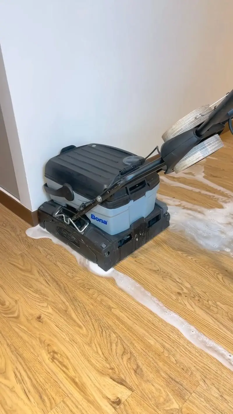 An OCD floor scrubber on a protected timber floor